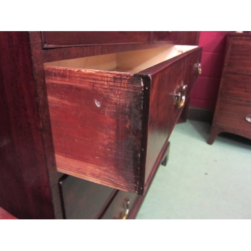 4129 - A George III flame mahogany chest of two short over three graduating long drawers having brass swan ... 