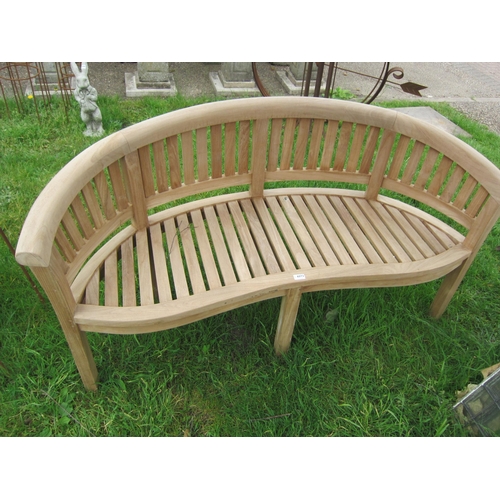 6073 - A curved teak garden bench