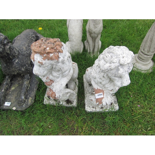 6086 - A pair of weathered terracotta seated lions, 20