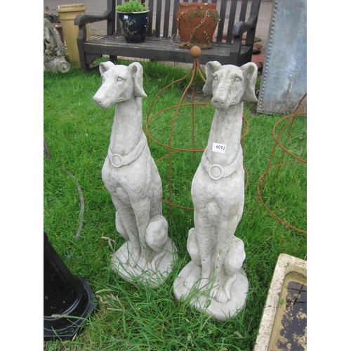 6093 - A pair of seated composition hounds, 32