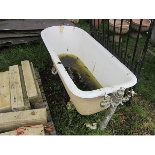 6121 - An early 20th Century French double ended roll top bath on claw feet with waste