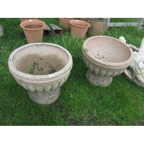 6123 - A pair of red sandstone semi-gadrooned urns, 19