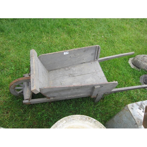 6138 - A rustic wooden childs wheelbarrow