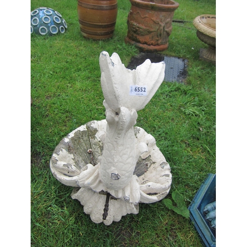 6552 - A painted composition shell form bird bath surmounted by fish