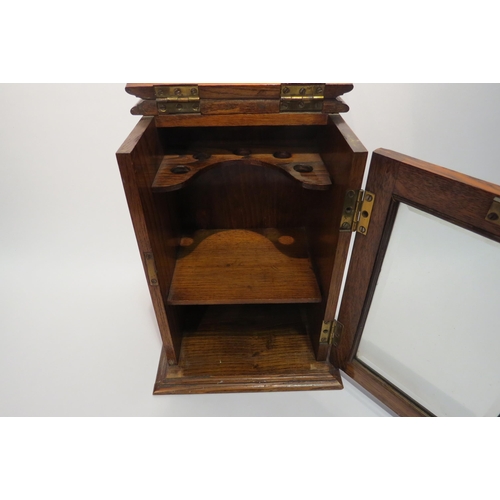 4025 - An oak pipe smokers cabinet with bevelled glass door. No Key. 21.5cm x 20cm x 28cm