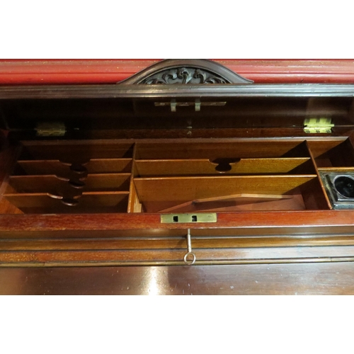 4052 - A Circa 1900 mahogany Davenport, the raised top with fitted interior and key over a rising tooled le... 