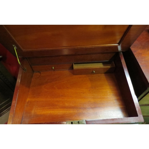 4052 - A Circa 1900 mahogany Davenport, the raised top with fitted interior and key over a rising tooled le... 