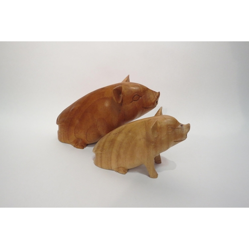 4056 - Two carved wooden pigs, tallest 16cm