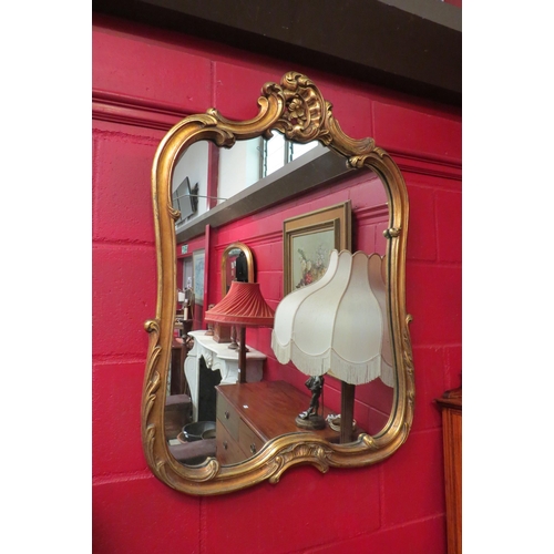 4128 - A gilt framed Rococo style wall mirror, 92cm x 66cm total
