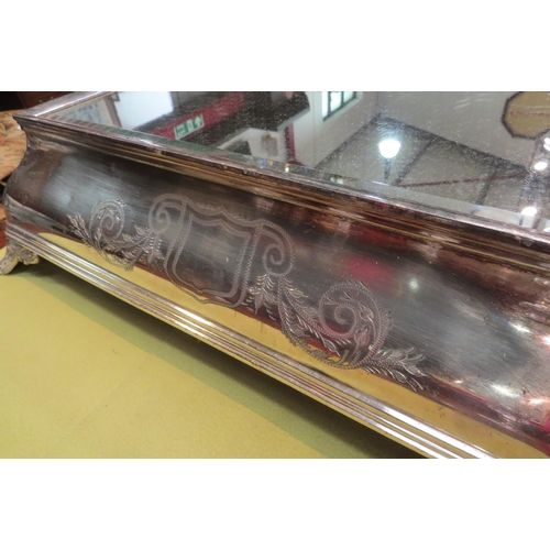 4151 - A plated wedding cake stand. Engraved decoration, bevelled mirrored glass top. Mirror plate 38cm x 3... 