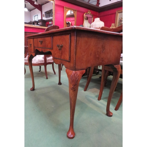 4162 - A George III revival flame walnut and crossbanded side table/lowboy with three drawers and shaped ap... 