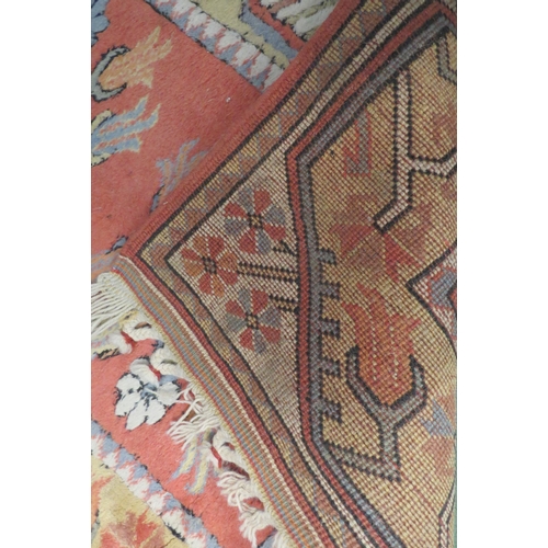 4171 - A peach ground Eastern wool rug, three central gulls and stepped border together with a chinese oval... 