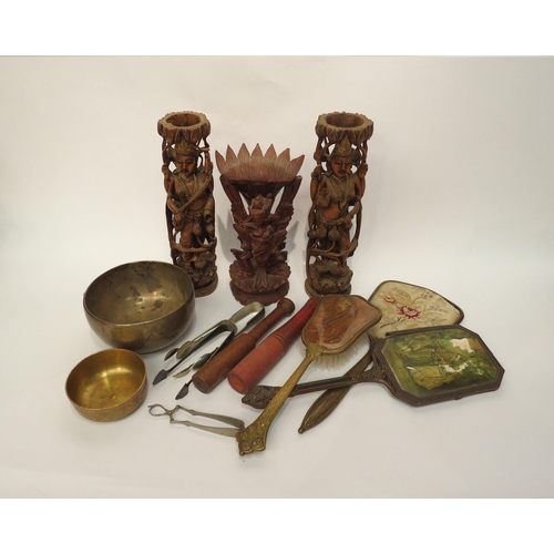 4180 - A carved treen figure and a pair of figures, singing bowl, sugar nips and hand mirrors