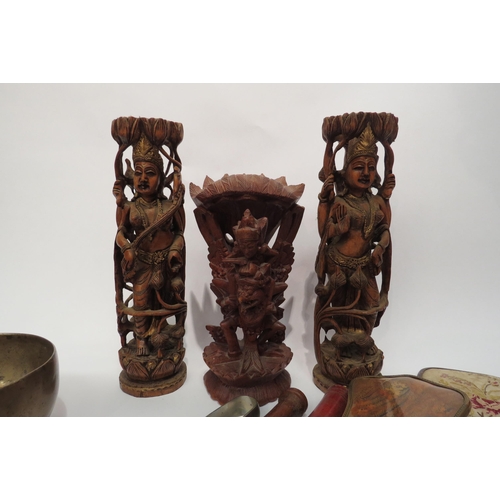 4180 - A carved treen figure and a pair of figures, singing bowl, sugar nips and hand mirrors