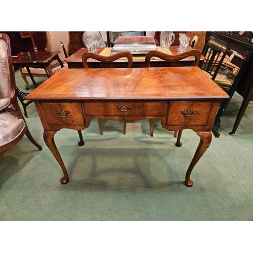 4162 - A George III revival flame walnut and crossbanded side table/lowboy with three drawers and shaped ap... 