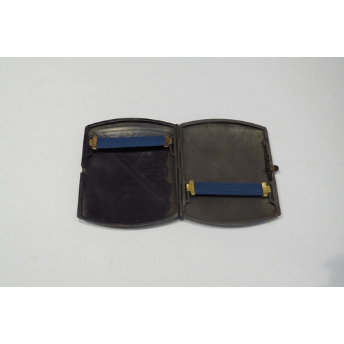 4303 - A damascene cigarette case with dragon and floral decoration