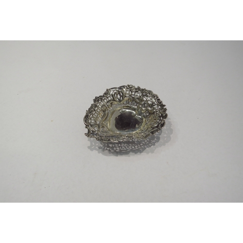 4304 - A silver heart shaped bonbon dish with pierced and embossed decoration on three ball feet.  Birmingh... 