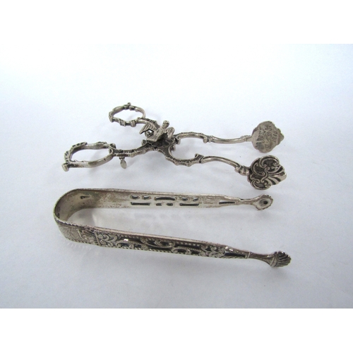 4312 - A pair of unmarked 18th Century sugar nips, the pivot surmounted by dove, the ends engraved and a pa... 