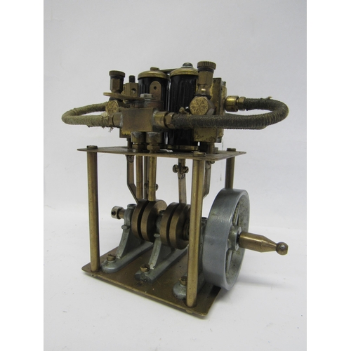 7377 - A brass live steam vertical twin cylinder steam engine with flywheel, 11.5cm tall