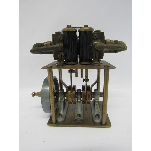 7377 - A brass live steam vertical twin cylinder steam engine with flywheel, 11.5cm tall