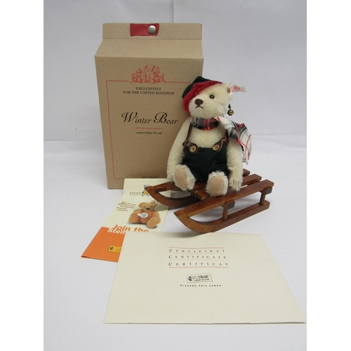 7112 - A boxed Steiff limited edition 654817 Winter Bear with wooden sledge, the articulated white mohair b... 