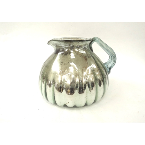 4328 - A 19th century oversized hand-blown mercury glass jug, fluted body, deterioration to the mercury to ... 