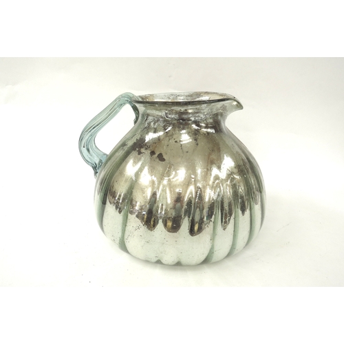 4328 - A 19th century oversized hand-blown mercury glass jug, fluted body, deterioration to the mercury to ... 
