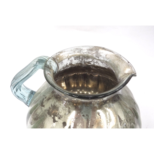 4328 - A 19th century oversized hand-blown mercury glass jug, fluted body, deterioration to the mercury to ... 