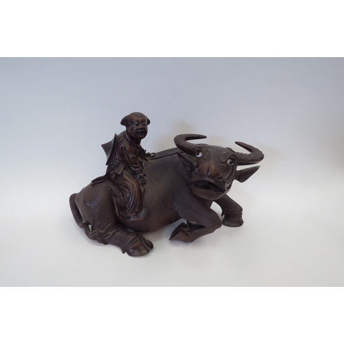 1102 - A Chinese carved wood water buffalo being ridden by a boy, 21cm tall