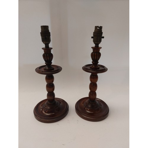 1101 - A pair of Edwardian turned wood lamps with weighted bases, 34cm tall