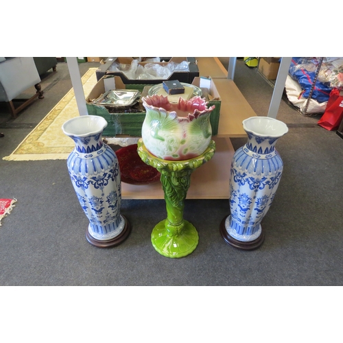 1093 - A pottery jardiniere on stand (a/f) and a pair of blue and white vases on stand, one a/f (3)