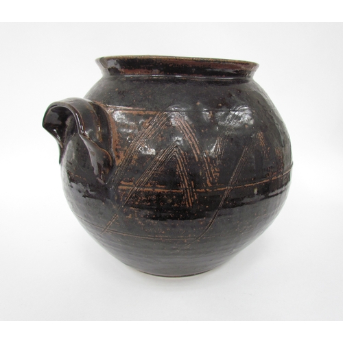 7098 - A studio pottery large jar, minus lid, believed to be by Michael Cardew. Tenmuko glaze with incised ... 