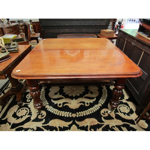 1109 - An early Victorian mahogany extending dining table, round-cornered top, on fluted supports to castor... 