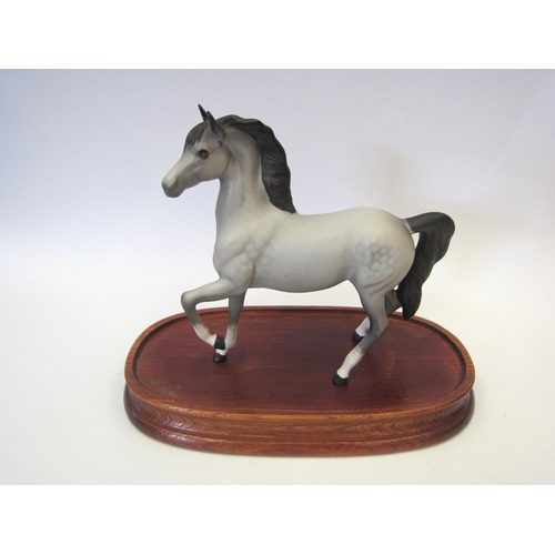 8084 - A Beswick Palomino (prancing Arab type) in grey matt, model no. 1261 (ear restored) on wooden plinth