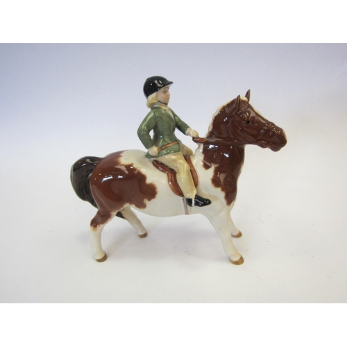 8121 - A Beswick Girl on Pony in skewbald gloss, model no. 1499