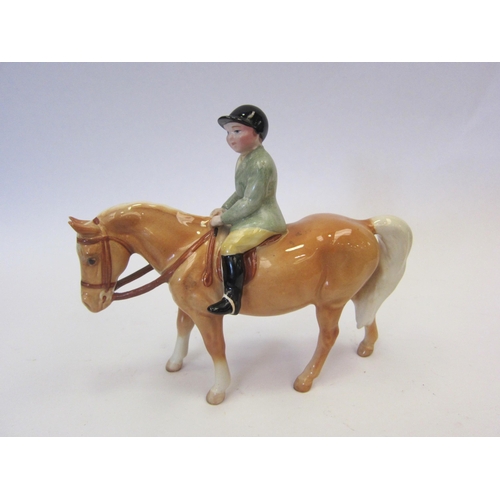 8125 - A Beswick Boy on Pony in Palomino gloss, model no. 1500 (pony ear repaired)