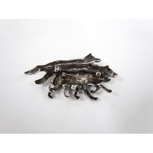 7255 - A silver brooch depicting three Wolves marked Sterling SC (silver cloud) 1980's.  7cm long x 4cm