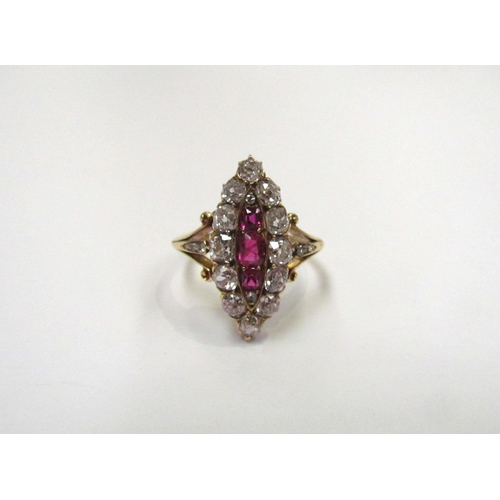 9298 - An old cut diamond and ruby navette ring the central three vertical set rubies framed by old cut dia... 