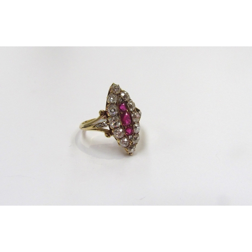 9298 - An old cut diamond and ruby navette ring the central three vertical set rubies framed by old cut dia... 