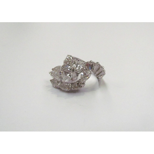 9150 - A diamond cluster ring, set with a sweep of 11 pear cut diamonds flanked by baguette cut diamond set... 