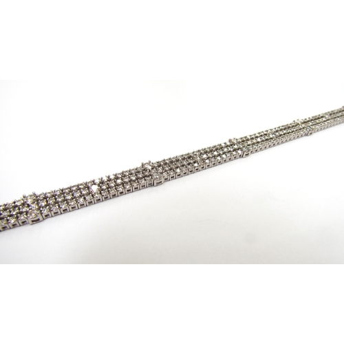 9421 - A white gold three row flexible diamond bracelet, 6ct total approx, stamped 18k, 18cm long, 18.3g