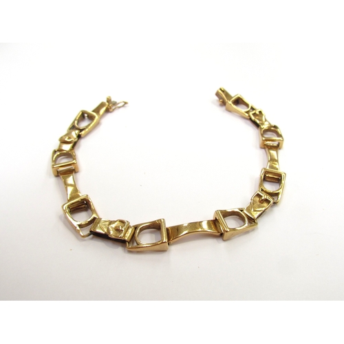 9285 - An 18ct gold bracelet with double horse bit and buckle style links, marks rubbed, 17.5cm long, 24.4g