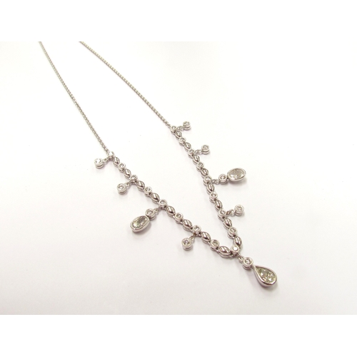 9420 - A white gold diamond set chandelier necklet, set with round, oval and pear shaped diamonds all in ru... 