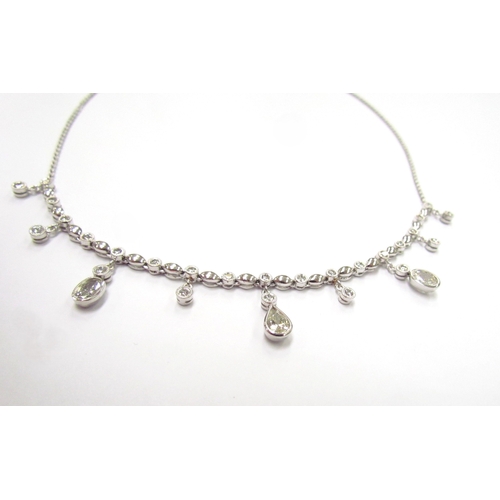 9420 - A white gold diamond set chandelier necklet, set with round, oval and pear shaped diamonds all in ru... 