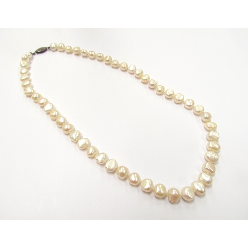 9407 - A single strand irregular shape pearl necklace, clasp stamped sterling, 46cm long            (C)