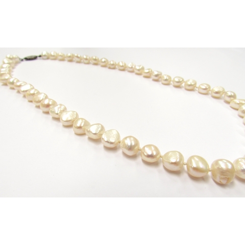 9407 - A single strand irregular shape pearl necklace, clasp stamped sterling, 46cm long            (C)