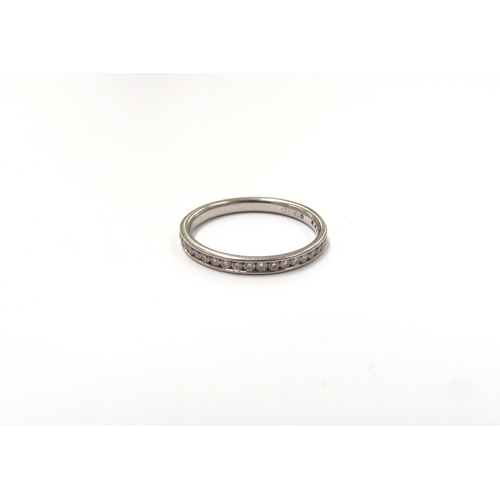 9039 - A platinum diamond set band. Size K/L, 2.2g