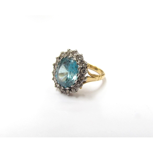 9304 - A blue zircon and diamond cluster ring, stamped 18ct. Size K, 5g (zircon is chipped)