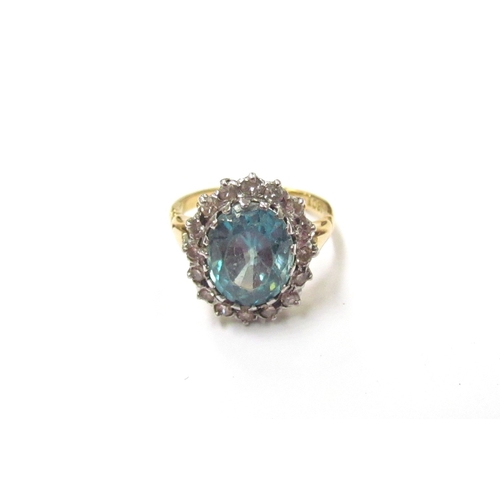 9304 - A blue zircon and diamond cluster ring, stamped 18ct. Size K, 5g (zircon is chipped)