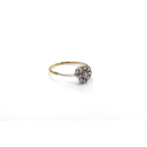 9319 - A diamond daisy ring, shank stamped 18ct. Size M, 1.2g